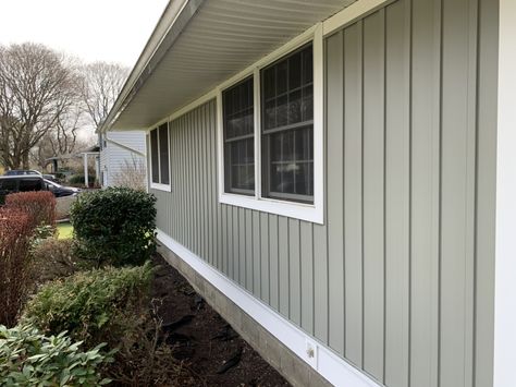 Georgia Pacific board and batten siding color Thistle on ranch style home Board And Batten Ranch House, Light Green Board And Batten Exterior, Small Ranch Board And Batten Exterior, Cream Board And Batten Exterior, Sage Green Board And Batten Exterior, Board And Batten Siding Ranch Home, Vinyl Board And Batten Siding, White Board And Batten Exterior Ranch, Green Ranch House Exterior