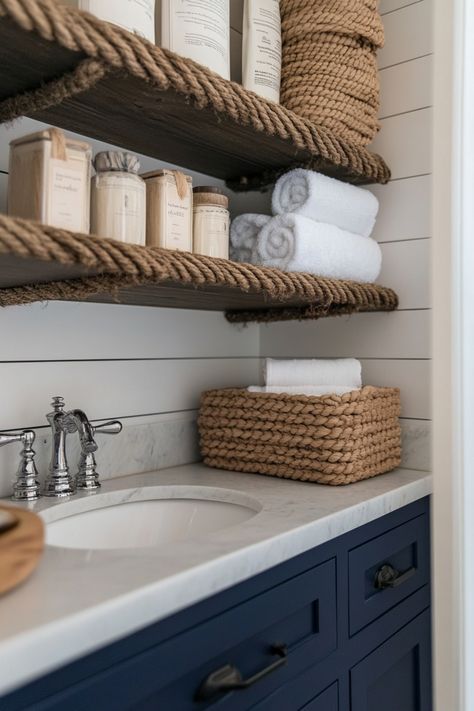 Bathroom with driftwood shelves and rope-wrapped hardware, paired with navy-blue accents and brass fixtures. Nautical Bathroom Shelves, Driftwood Shelves, Driftwood Shelf, Bathroom Ideas Decor, Nautical Bathroom, Coastal Bathroom, Coastal Bathrooms, Ideas For Bathroom, Bathroom Inspo