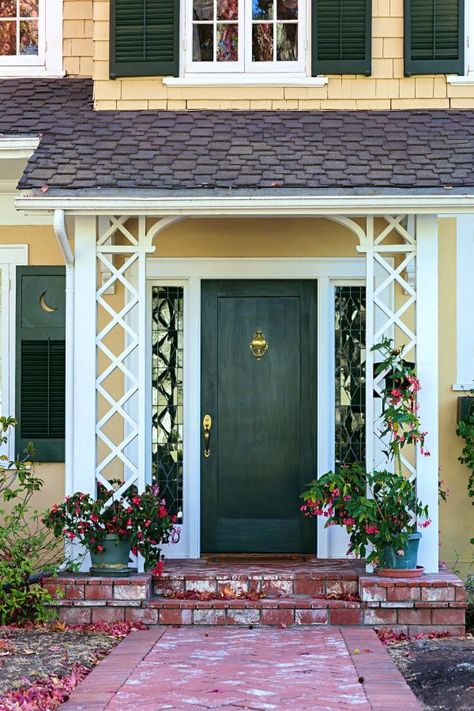 Green Front Door on Yellow Colonial Style Home Arches Facade, Dark Green Front Door, Green Home Exterior, Porch Trim, Green Front Door, Cottages By The Sea, Green Front Doors, Lake Houses Exterior, House Green