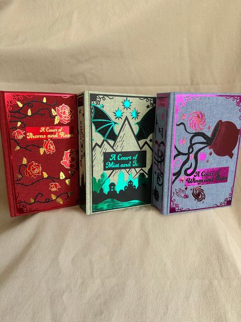 ACOTAR Series Rebinds (Books 1-3) Watch the rebinding series: @babblingbookcrafting on TikTok or Instagram! Includes: A Court of Thorns and Roses, A Court of Mist and Fury, and A Court of Wings and Ruin Each rebound book is designed and handcrafted by me! The covers and colors are inspired by the books on which they are based.  Each design is between 3-4 layers of vinyl. Due to the intricacy, and this being a hand done rebind, it may not be completely perfect, but it will be made with lots of lo Rebinding Books, Acotar Rebind, Book Rebind, Acotar Original Covers, Acotar Special Edition, Rebound Book Covers, Acotar Book Rebind, A Court Of Thorns And Roses Mini Book Cover, Acotar Hardcover Set