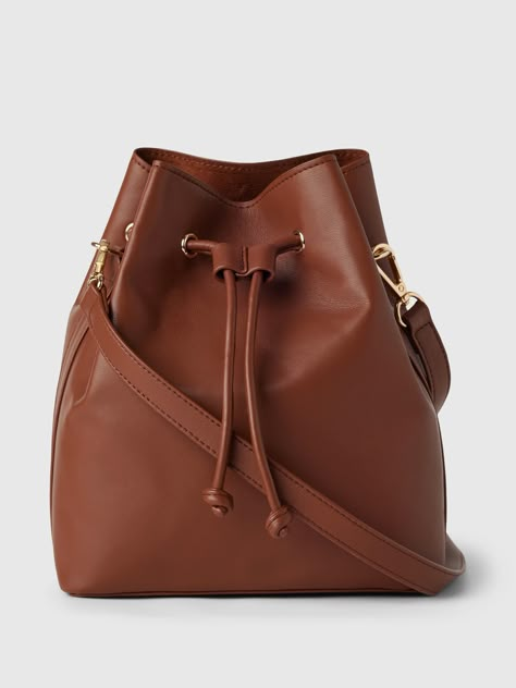 This bucket bag is made with vegan leather.  Shoulder strap.  Drawcord closure at top.  Inner pocket.  Faux suede lining.  Dimensions: 9"H x 4" W x 7. 5" L Gap Bag, Bucket Purse, Chic Summer Outfits, Makeup Rooms, Fall Fits, Leather Bucket Bag, Leather Bucket, The Gap, Work Life