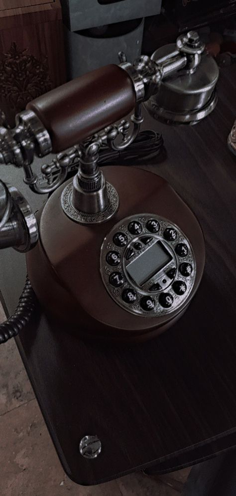 its an old vintage style phone, giving 80's aesthetics vibe, in a dark academia style Old Phone Aesthetic Dark, Vintage Business Aesthetic, Dark 1950s Aesthetic, Old Phone Aesthetic Vintage, Vintage 1930s Aesthetic, Gramophone Aesthetic, Dark Academia Character Design, Old Phone Aesthetic, Old Fashioned Aesthetic