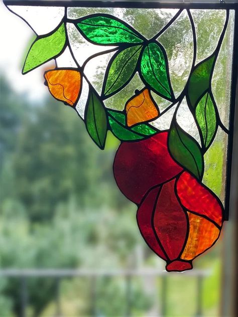 We replenished our collection of garnets with a corner stained-glass window. The pendant for the window is made in the Tiffany technique from different shades of red and green glass. To emphasize the pomegranate branch, we used light yellow glass for the background. Just look, these bright window hangings give the feeling of a pomegranate tree outside your window. The suncatcher grenade is attached to a chain. Christmas Gifts Kitchen, Stained Glass Corner, Pomegranate Branch, Stained Glass Tree, Pomegranate Tree, Different Shades Of Red, Kitchen Christmas Gifts, Corner Window, Glass Tree