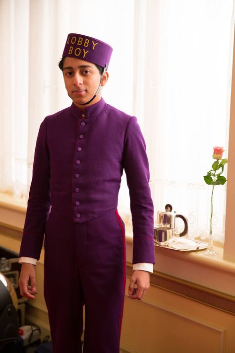 Tony Revolori as Zero Moustafa. "What is a lobby boy? A lobby boy is completely invisible, yet always in sight. A lobby boy remembers what people hate. A lobby boy anticipates the client's needs before the needs are needed." -- M. Gustave H, Chief Concierge of The Grand Budapest Hotel (2014). Favorite Wes Anderson film thus far! Tony Revolori, Red Hotel, Lobby Boy, Hotel Concierge, The Grand Budapest Hotel, Wes Anderson Movies, Best Costume Design, Wes Anderson Films, Hotel Uniform