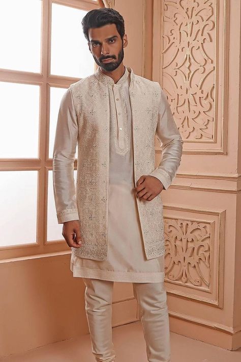 Whether you are planning to attend a friend’s Mehndi or going to a Sangeet ceremony, a kurta with jacket for men is more versatile than your usual run-of-the-mill options. Here's how! Kurta Pajama Jacket For Men, Kurta Pajama With Long Jacket, Men Kurta With Jacket, Kurta With Long Jacket For Men, Kurta Pajama Jacket Men, Kurta With Jacket For Men, Long Jacket Outfit, Kurta With Jacket, Groom Clothes