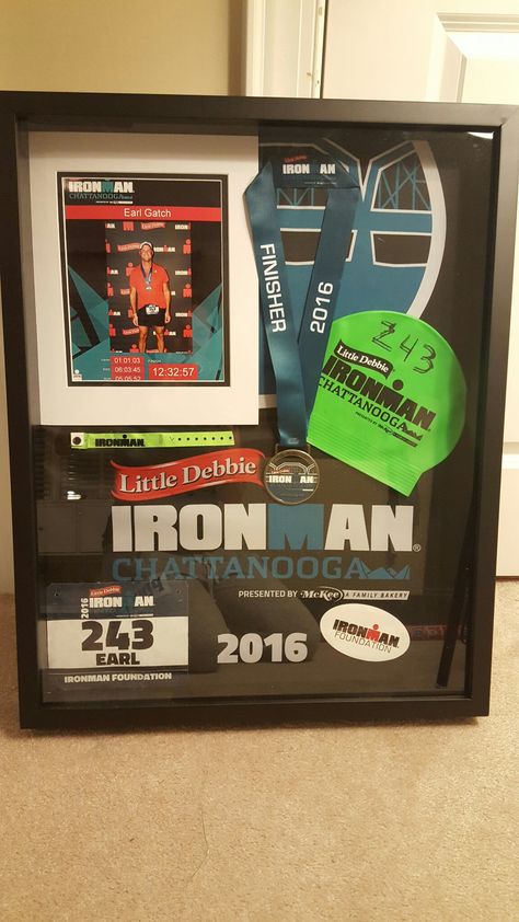 Ironman shadow box was homemade for my husband. Shadowbox from Hobby Lobby ($50 after coupon). Display your ironman, marathon or triathlon race medal, swim cap, race bib and other memorabilia. Simple, easy and way cheaper than having it professionally done. All you need is hot glue gun and a few pins and a vision. Make sure to keep lots of things from race day. Ironman Chattanooga 2016 Race Bib Display, Race Medal Holder, Race Medal Displays, Marathon Medal Display, Iron Man Race, Triathlon Motivation, Race Medal, Running Medals, Race Bibs