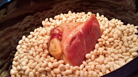 These slow-cooker navy beans are seasoned with smoky ham hock, slow cooked into a rich creamy pot of beans. A hearty meal on a cold winter day! | TheMountainKitchen.com Ham Hock Slow Cooker, Ham Hock And Beans, Navy Beans Recipe, Navy Bean Recipes, Black Bean Recipe, Beans Crockpot, White Beans And Ham, Ham Hock Recipes, Pot Of Beans