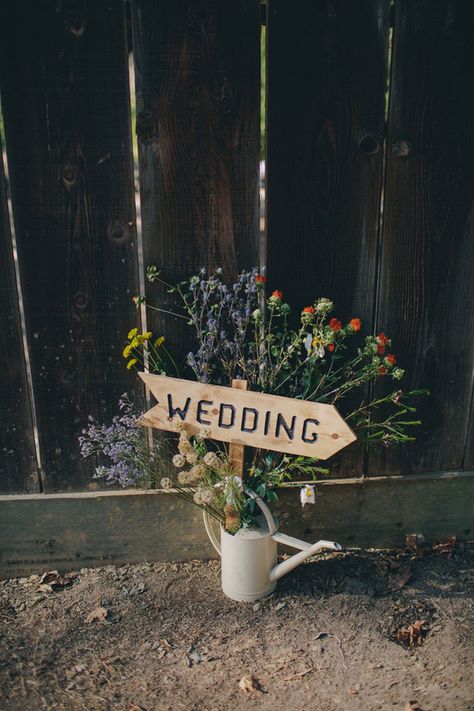 Roya and Ryan’s Colorful California Cabin Wedding on @intimatewedding Photography by @lindsgomes #weddingsign #rusticwedding Entrance Idea For Wedding, Woodsy Summer Wedding, Rustic Home Wedding, Wedding Decor Natural, Backyard Wedding Signage, Rustic Cabin Wedding Decor, Wedding By The River, Woodsy Wedding Theme, Cottage Wedding Ideas