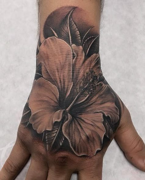 Flower Tattoo Hand Men, Flower On Hand Tattoo Men, Lily Flower Hand Tattoo, Hibiscus Flower Hand Tattoo, Black And Grey Hibiscus Tattoo, Hand Flower Tattoo Men, Mens Lily Tattoo, Tropical Hand Tattoo, Hawaiian Hand Tattoo