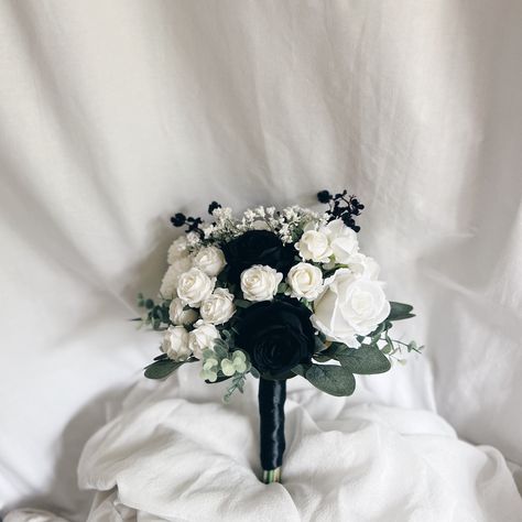 This beautiful artificial wedding bouquet is  made from faux flowers of white and black and silk eucalyptus of green and black. They will make the perfect addition to your big day!  The stems are wrapped in black satin ribbon. The bridal bouquet pictured is 12" (30 cm). Bouquet Size Available: Bridal Bouquet- 12" (30 cm) Bridesmaids Bouquet - 8" (20 cm) Toss bouquet 6" (15 cm) Matching bridesmaids bouquets, toss bouquet, corsages and boutonnières and other accessories are available. Bouquet For Black Dress, Wedding Bouquets Black And White, Black And White Bride Bouquet, Black White Wedding Bouquet, Black And White Flowers Bouquet, Black And White Bouquet Wedding, White And Black Bouquet, Black And White Bridal Bouquet, White And Black Flower Bouquet