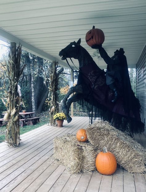 Headless Horseman prop with bails of hay to hide any cords and the fog machine. Added more pumpkins and cornstalks and mums to his workshop porch for the spooky effect! 🎃 Headless Horseman Outdoor Decoration, Halloween Headless Horseman, Halloween Decorations Outdoor Werewolf, Spooky Outdoor Decor, Salem Outdoor Halloween Decor, Headless Horseman Halloween Decorations, Headless Horseman Yard Decoration, Headless Horseman Decoration, Headless Horseman Scarecrow