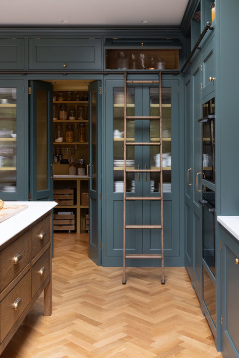 The tall run of cabinets is a striking and functional feature in this kitchen. At each end, the two double-door cupboards are dedicated crockery cupboards with fluted glass doors that open to reveal beautifully crafted oak interiors with matching oak shelves, perfect for organizing and displaying tableware. The two central doors are cleverly designed as 'secret doors' that lead directly into the walk-in pantry, blending seamlessly with the surrounding cabinetry. Tall Pantry Cupboard, Double Doors To Kitchen, Kitchen With Ladder, Tall Kitchen Cabinets Ideas, Fluted Glass Kitchen Cabinets, Pantry With Ladder, Full Height Kitchen Cabinets, Kitchen Tall Cabinet, Kitchen With Glass Cabinets