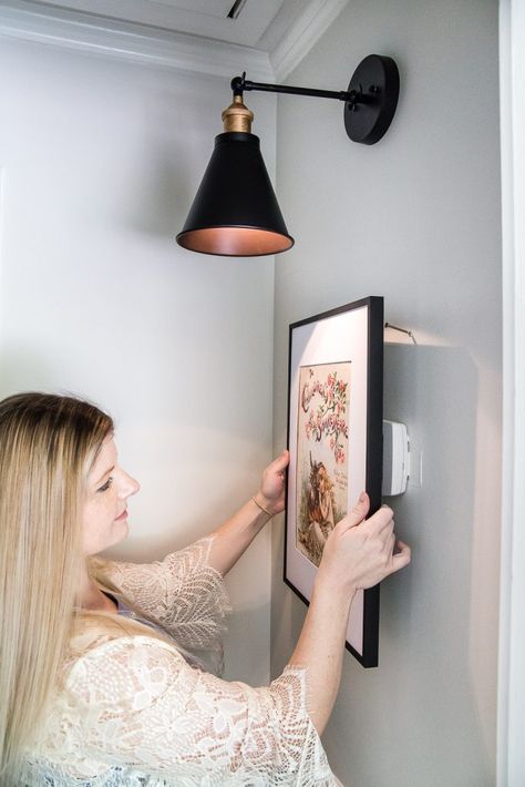 Simple Thermostat Cover and Hallway Progress | A dark, beige hallway gets a light and bright makeover, plus a solution for creating an inexpensive thermostat cover and sconce lighting without the electrical work. #thermostatcover #hallway #hallwaymakeover #beforeandafter #sconce #sconcelight #walldecor #wallart #budgetdecor #freeart #decortrick #eyesorecover Simple Thermostat Cover Beige Hallway, Affordable Apartment Decor, Thermostat Cover, Hallway Makeover, Hiding Ugly, Vanity Makeover, Room Tips, Farmhouse Side Table, Shower Design