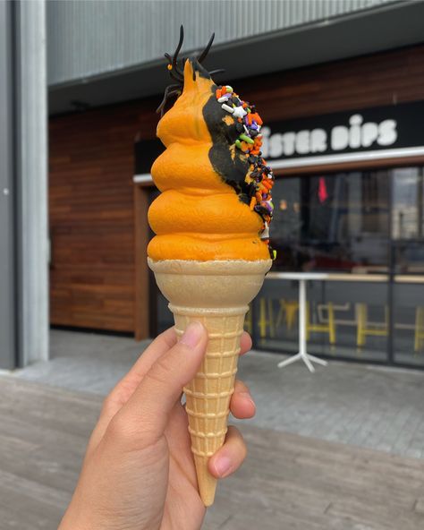 Halloween themed soft serve in New York. It’s orange soft serve dipped slightly in chocolate with a small fake spider as decoration New York City, Ice Cream, Cream