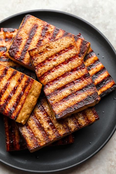 In this Grilled Tofu recipe, thick tofu slabs are marinated in a delicious 5-ingredient marinade before being charred to perfection on a hot grill. It’s an easy cooking method that gives you delicious and tender tofu every time! Marinated Tofu Recipes, Grilled Tofu Recipes, Ways To Cook Tofu, Veggie Kebabs, Best Veggie Burger, Tofu Steak, Tofu Marinade, Vegan Potato Salads, Quick Easy Vegan