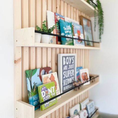 Homemade Wall Bookshelves, Diy Slat Wall Bookshelf, Slatted Wall Bookshelf, Picture Ledge Book Shelf Kids Rooms, Diy Nursery Shelves Bookshelves, Wood Slat Bookshelf, Diy Wall Shelf For Books, Book Shelf Accent Wall, Slat Wall In Dining Room