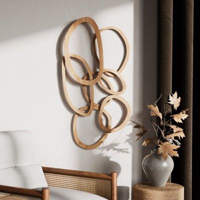 Inspired by the timeless charm of bohemian aesthetics, this abstract wall art offers an organic visual journey. Set in a rich, natural wood tone, each shape evokes thoughts of nature's cycles, the interconnectedness of life, and the spirit of wanderlust. The deep brown hues further accentuate the intricate details and natural wood grain patterns. Such a piece doesn't just serve as wall art but also as an ode to nature and the timeless tales of boho culture. This art style seamlessly blends with Wall Decor For Tall Ceilings, Decor For Small Wall Space, Main Living Room Wall Decor, Wood Abstract Wall Art, Wall Decor For High Ceilings, Rustic Modern Wall Decor, Rectangle Wall Decor, Abstract Wood Wall Art, Over Buffet Wall Decor