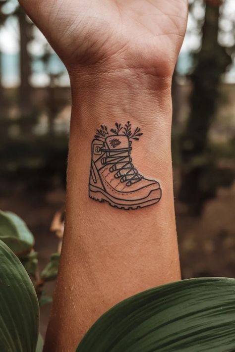 Tattoo of a hiking boot with small plants growing out of it on a forearm. Wrist Tattoo Designs For Women, Wrist Tattoo Designs, Wrist Tattoo Ideas, Forest Silhouette, Exploring Nature, Tattoo Ideas For Women, Wrist Tattoos For Women, Wrist Tattoo, New Tattoo