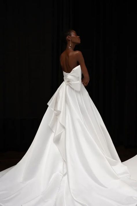 The Gracelyn gown, cut in our lustrous new satin taffeta makes a timeless yet striking statement. The clean lines of the scoop neckline are elevated by thoughtful draping through the bodice. The full A-line skirt is impossibly flattering and effortlessly romantic. The back of the gown is adorned with an arrestingly dramatic and modern bow that cascades down the back of the gown to leave a lasting impression. Modern Bridal Dress, Jenny Yoo Collection, Gowns For Women, Jenny Yoo, Which Is Better, Bride Gowns, Modern Bridal, Gowns Online, Bridal Boutique