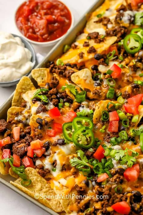 Every kitchen needs a fabulous nachos recipe like this one! Covered with beef, black beans, and melted cheese, these nachos are truly supreme. #spendwithpennies #nachosrecipe #recipe #appetizer #nachossupreme #loadednachos #easy #best #beef #chicken Basic Nachos Recipe, Supreme Nachos, Ground Beef Nachos, Best Nacho Recipe, Nachos Recipe Beef, Baked Nachos, Nachos Supreme, Chicken Nachos Recipe, Cheesy Nachos