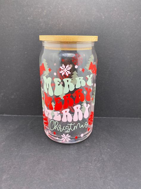 🎄 Merry Merry Merry Christmas 16 ounce Libbey Glass 🎅🏽 The perfect cup for your holiday beverages! From iced coffee to bottled bubbly this cup can hold it all. This holiday-themed cup is cute and the perfect spooky accent for your holiday decor.  ⭐️ Libbey 16 oz. glass can jar ⭐️ Decal is made with permanent vinyl ⭐️ COMES WITH STRAW AND LID 🧽 CUP CARE * Not dishwasher safe * Not microwave safe * Hand wash only * Avoid extreme heat * Do not soak! 📦 SHIPS FREE TO ANYWHERE IN USA 📦 Christmas Tumblers Vinyl, Christmas Cup Svg, Christmas Libbey Cup, Christmas Cup Ideas, Christmas Vinyl Ideas, Christmas Cups Vinyl, Christmas Glass Cups, Diy Christmas Mugs, Holiday Beverages