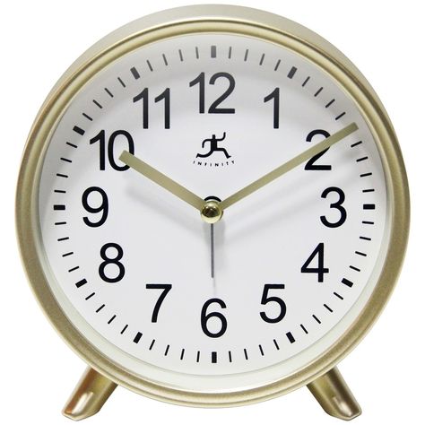 The Gold Tabletop Alarm Clock is a simple yet striking piece that provides the perfect accent to any room in your home. This tabletop alarm clock features a matte gold finish on a durable molded plastic frame. The Gold Tabletop Alarm Clock also features gold metal hands and easy-to-read Arabic numerals on a white face. With its easy-to-use alarm with a loud ringing bell, it can clearly be heard by anyone. At 5.75 inches, this attractive alarm clock can be placed on your mantel, by the bed, coffe Ringing Bell, Analog Alarm Clock, Bedside Clock, Analog Clock, Tabletop Clocks, Modern Boutique, Table Clock, White Face, Modern Desk