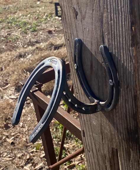 Looking for a gift for the horse lover in your life, something simple to hang in your barn, ok even something unique to go with your western/rustic home decor.  Simple horseshoe cowboy hat hanger.  Made from 3 horseshoes cut and welded together.  The hat hanger is made from new horseshoes.  Great for holding your favorite hat up and out the way. It will hold other hats as well besides cowboy hats.  It comes pre-drilled with 2 holes that are 1/4 inch in diameter for mounting.  Due to different mo Horseshoe Hat Rack, Horse Shoe Welding, Western Rustic Home Decor, Cowgirl Essentials, Cowboy Hat Hanger, Horseshoes Ideas, Horseshoe Decorations, Horseshoe Cowboy, Hat Hangers