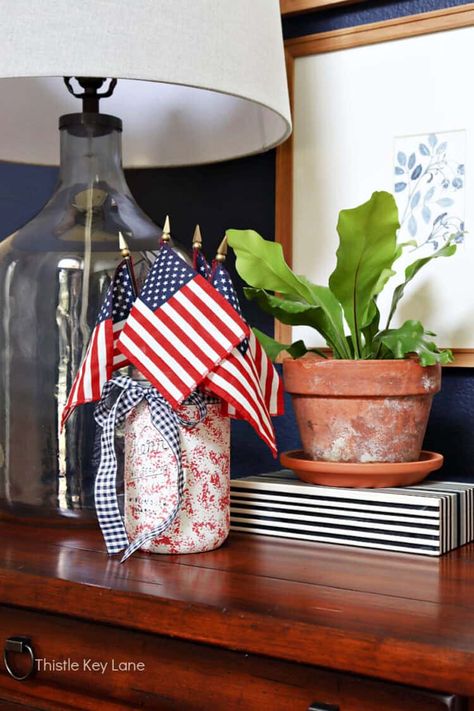 Favorite July 4th Decorating Ideas - Get ready for summer celebrations with these simple patriotic decorating and craft ideas. How to decorate with American flags. Decorating with patriotic red, white and blue for July 4th. Patriotic Vignettes. Patriotic Centerpiece Ideas. Mini Flag Centerpiece, Patriotic Centerpieces, Easy Pillows, Patriotic Fabric, Mini Flags, Flower Bucket, 4th Of July Celebration, Summer Celebration, Americana Decor