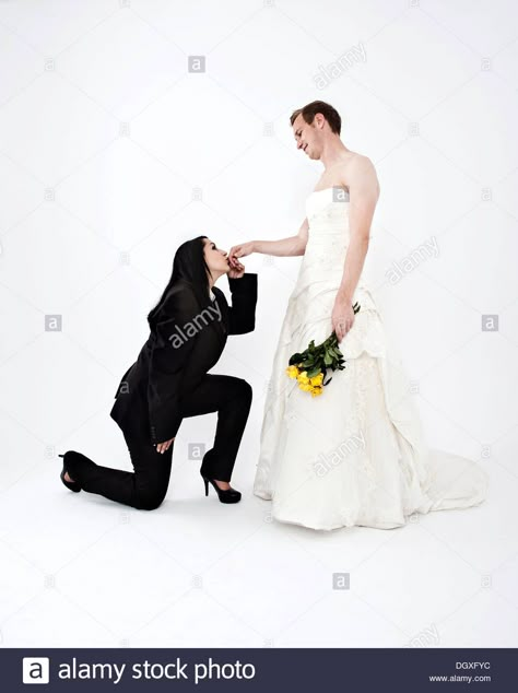 Bride wearing a suit kissing the hand of a groom wearing a wedding dress, exchange of wedding clothing, Austria Female Wedding Suit, Corpse Bride Dress, Kissing Poses, Worst Wedding Dress, Guys In Skirts, Bride Suit, Clothes Swap, Asian Style Dress, Woman In Suit