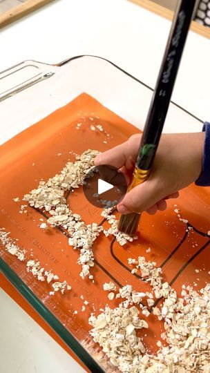 3.3K views · 103 reactions | Turning learning into a sensory adventure! ✨ 

Today we tried this fun activity where I wrote a letter on paper, placed it under a glass baking dish, and covered it with oats. My little one used a paintbrush to sweep the oats and trace the letter beneath—such a simple yet engaging way to practice letter recognition!

This hands-on activity not only kept him entertained but also helped strengthen fine motor skills and focus. Plus, it’s super easy to set up with things you already have at home! | Chris Anna | Minimal effort  Craft, Play activities Letter Of The Week, Preschool Letters, Glass Baking Dish, Letter Recognition, Play Activities, Alphabet Activities, Fine Motor, Teacher Hacks, Hands On Activities