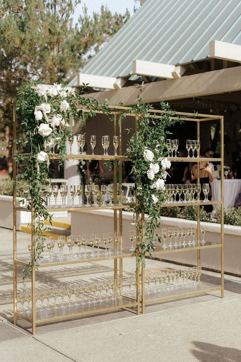 With a vision for elegance and an enchanted white floral wedding, this bride and groom gave their guests an extravagant experience Champagne Ideas Decorations, Champagne Toast Display, Champagne Wedding Entrance, Wedding Cocktail Bar Ideas, Outside Wedding Cocktail Hour, Elegant Cocktail Hour Decor, Champagne Wall Engagement Party, Wedding Cocktail Hour Details, Elegant Wedding Cocktail Hour