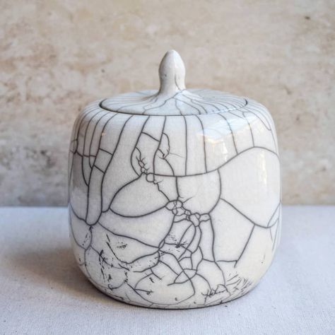 Raku lidded jar. This one is made of porcelain, which shows the crackle pattern of the glaze in a distinct way. . . .… Raku Ware, Pottery Inspo, Raku Pottery, Glaze Ceramics, Crackle Glaze, India Ink, Pottery Ideas, Jar Lids, Decorative Jars