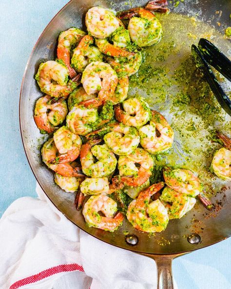 Pesto shrimp is a dinnertime win! Savory basil pesto is a natural pairing with juicy shrimp; serve with pasta or rice for an easy dinner idea. | healthy dinner recipes | shrimp recipes | recipes with pesto | quick and easy weeknight meals |  #pestoshrimp #shrimp #pesto #pestorecipe #shrimprecipe #easyshrimprecipe #healthyshrimp Pesto Shrimp, Creamy Shrimp Pasta, A Couple Cooks, Famous Duos, Juicy Shrimp, Basil Recipes, Healthiest Seafood, Vegetarian Cookbook, Couple Cooking