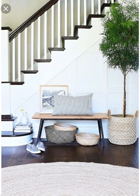 Small bench with round rug and greenery Small Entry Stairs, Front Of Stairs Decor, Bench By Stairs, Entryway Stairs Decor Front Entry, Mud Cupboard, Bench Under Stairs, Entryway With Stairs, Ideas For Under The Stairs, Stairs Bench