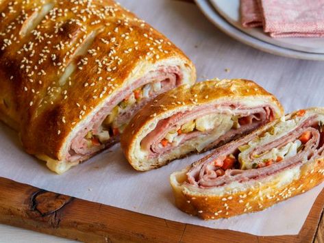 Recipe of the Day: Muffuletta Garbage Bread | We love a good muffuletta, the classic New Orleans sandwich stuffed with Italian deli meats, cheese and olive salad. Here, we've wrapped all the good stuff up in pizza dough, then baked it, making a melty and delicious sandwich experience perfect for Mardi Gras. Garbage Bread Recipe, Garbage Bread, Italian Deli, Deli Meats, Delicious Sandwiches, Deli Meat, Food Goals, Kitchen Food, Provolone