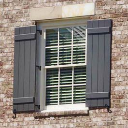 greyish blue board and batten shutters hinged on brick Shutters Before And After Exterior, Outdoor Shutter Paint Colors, Real Shutters Exterior, Exterior Window Shutters On Brick, Modern Outdoor Shutters, Window Shutters Exterior Brick House, European Shutters Exterior, Gray Shutters Brick House, Board And Batten Shutters Exterior