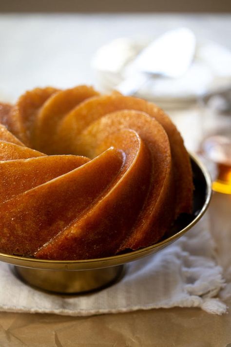 If you're a bourbon drinker, this Kentucky Bourbon Buttermilk Cake the perfect cake for you. This cake is a beautiful golden brown with a buttery bourbon glaze infused throughout. The texture of the cake is amazing and the slightly boozy flavor adds something special. The cake itself is simple to make with basic ingredients. Even if you aren't a fan of bourbon, you may still like this cake. The alcohol gets cooked off enough that the flavor isn't overwhelming. You can also try it with a differen Bourbon Cake Recipe, Bourbon Cake, Whiskey Cake, Buttermilk Cake, Bourbon Glaze, Lemon Bundt Cake, Kentucky Bourbon, Bundt Cakes Recipes, Spiced Rum