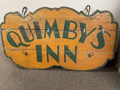 (eBay) Antique Quimby’s Inn 1x Thick Wooden Hanging Sign. This is an original advertising sign for an old Inn In mustard and forest green with 2 heavy iron hooks at the top for hanging. This sign is probably almost 100 years old so it needs some restoration, it’s intact but someone put metal clips on the between the op and middle board for stability. I’m sure you can remove and reglue for strength. It measures 36”across and 20.75” tall. No returns so ask all questions before bidding. Camp Signage, Antique Trade Sign, Western Signs, Vintage Wooden Signs, Sign Photography, Exterior Signage, Trade Sign, Pub Signs, Craft Show Ideas