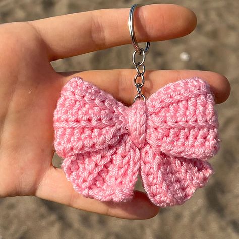 Cute Crochet Pink Coquette Bow Keychain Each toy is handmade by me and made to order. ✅SHIPPING Fast shipping - It will take 1-5 business days to print and ship 🚀 💚Each product is packed and shipped to you with lot of love and care 🧶Acrylic ✅SIZE Approx 5 cm width. ✅CARE INSTRUCTIONS - Wash by hand only. Soak in warm, soapy water without scrubbing. Allow to air dry. Avoid machine washing. - Do not bleach or iron. ✨Thank you so much for visiting my shop! If you have any questions, please feel Cute Crochet Things To Sell, Y2k Crochet Keychain, Crochet Bag Decoration, Diy Gifts Crochet, How To Crochet A Keychain, Tiny Things To Crochet, Crochet Keychain Cute, Crochet Bag Keychain, Crochet Bow Keychain