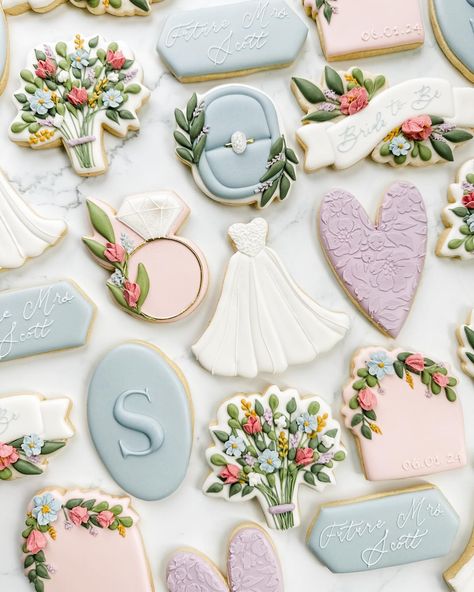 This photo stopped me in my tracks while I was scrolling through the dozens I took of this set (anyone else take WAY too many photos of every set 😅). It’s a different angle and most of the cookies are out of focus, but I love it! Swipe for a photo of the full set in a more traditional photo! This bride in bloom wildflower bridal shower cookie set was so fun to create! Their main wedding color is dusty blue so I focused on that and added in some of the floral tones from the invite. If you want... Spring Bridal Shower Cookies, Spring Wedding Cookies, Wildflower Bridal Shower Cookies, Floral Wedding Cookies, Love In Bloom Cookies, Love Is In Bloom Cookies, Blue Bridal Shower Cookies, Love In Bloom Bridal Shower Ideas, Floral Bridal Shower Cookies