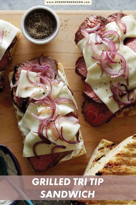 Our recipe for Grilled Tri Tip Sandwiches is so easy and crazy delicious! Filled with juicy and flavorful grilled tri tip, melted cheese, thinly sliced red onions, and sandwiches between two thick slices of ciabatta, it's one of our favorite sandwiches! #dinner #sandwich #grilling #summer #recipe Grilled Tri Tip, Tri Tip Sandwich, Tenderloin Sandwich, Pork Tenderloin Sandwich, Dinner Sandwich, Oven Baked Ribs, Spoon Fork Bacon, Baked Ribs, Sandwich Ingredients