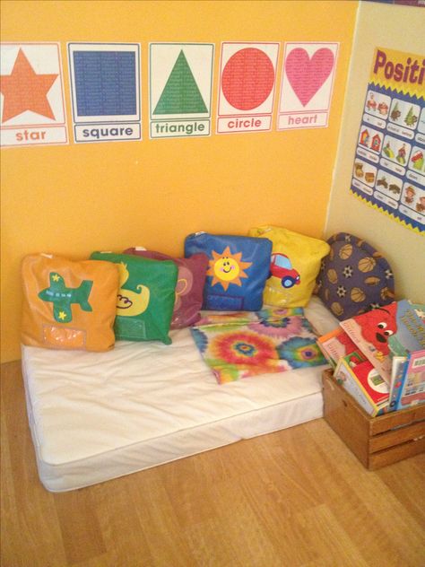 Home daycare reading area. Used a baby mattress, that I was no longer needing... Infant Cozy Area Daycare, Cozy Corner Infant Classroom, Daycare Reading Area, Simple Daycare Room, Daycare Cozy Corner Ideas, Reading Corner Daycare, Two Year Old Daycare Room Ideas, Learning Corner At Home Toddler, One Year Old Classroom Setup Daycare