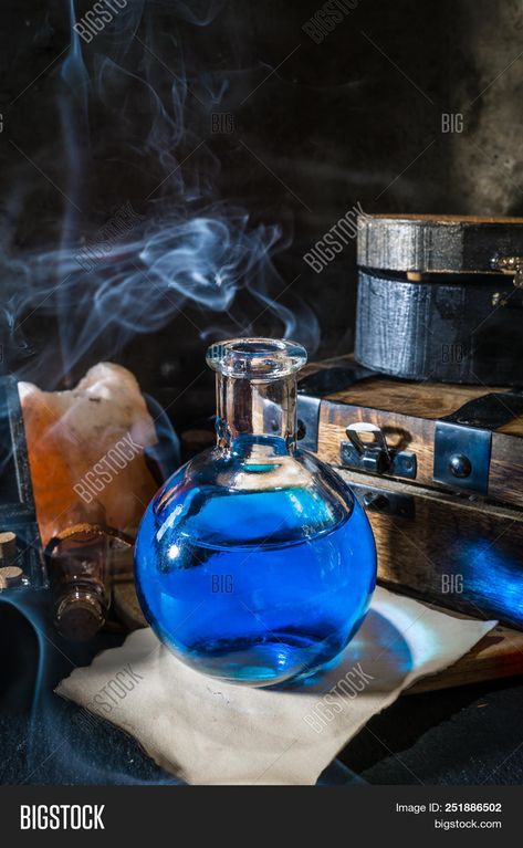 picture of Magic Concept. Blue Potion In Bottle, Candle, Old Wooden Boxes And Smoke. Magical Background stock photo Potion Aesthetic, Magical Background, Magic Concept, Magic Store, Old Wooden Boxes, Bottle Candle, Magic Bottles, Bottle Candles, Blue Magic