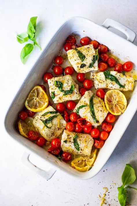 Simple Baked Cod with Tomatoes, Basil, Garlic and Lemon- a fast and easy weeknight dinner that is healthy and delicious! Keto and Gluten-free. #bakedcod #ketomeals #easyketorecipes #weeknightdinners #healthycodrecipes #bakedcodrecipes Baked Cod With Tomatoes, Cod With Tomatoes, Cod Recipes Healthy, Burst Tomatoes, Best Fish Recipes, Roasted Cod, Baked Cod Recipes, Healthy Weeknight Dinners, Easy Fish Recipes