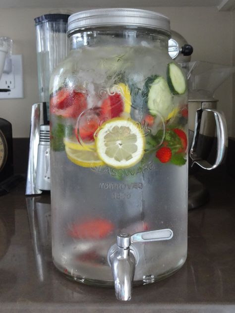 Homemade fruit water in a mason jar jug with spigot. Water Jar Aesthetic, Aesthetic Fruit Water, Fruit Water For Party, Water With Fruit In It For Party, Water With Fruit In It, Water Pitcher Ideas, Hotel Sleepover, Water With Fruit, Wine Party Appetizers