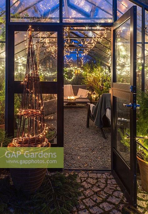 Greenhouse decorated for Christmas with tree, fairylights and candles - seen from the outside Christmas Greenhouse Decor, Greenhouse Christmas Decor, Christmas In The Garden, Decorated Greenhouse, Greenhouse Vibes, Greenhouse Dining Room, Greenhouse Dining, Christmas Greenhouse, Greenhouse Lighting