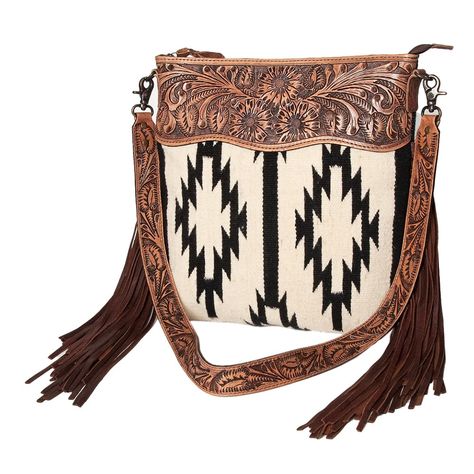 PRICES MAY VARY. American Darling is a proud OFFICIAL DESIGNER SPONSORS OF NEW YORK FASHION WEEK 2024 PREMIUM QUALITY MATERIAL: This is a handmade American Darling women's signature crossbody bag made with hand-weaved woolen saddle blanket fabric that gives it a traditional Western yet trendy and elegant look. High-quality soft and supple Eco friendly vegetable-tanned full grain Genuine leather and Hand tooled, carved, Eco friendly vegetable-tanned Cowhide Leather are also used to make this hand Louis Vuitton Western Purse, Western Christmas Wishlist, American Darling Purse, Western Purses And Handbags, Western Leather Purse, Western Bags Purses, Western Bags, Western Bag, Blanket Fabric