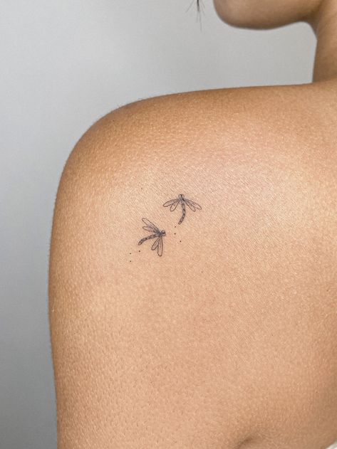 Fine line tattoo of two dragonflies. Los Angeles based tattoo artist. Perfect tattoo for women. Perfect tattoo for men. Perfect tattoo to match with a friend! #tattooartist #finelinetattoo #westerntattoo #losangeles #minimalisttattoo #uniquetattoo #tattooformen #tattooforwomen #flashdesign #halloweentattoo #matchingtattoos Mini Dragon Fly Tattoo, 3 Dragonflies Tattoo, Tattoo Ideas Dedicated To Parents, Tattoos To Get For Parents, Fine Line Dragon Fly Tattoos, Small Tattoo Dragonfly, Fine Line Beetle Tattoo, Two Bee Tattoo, 2 Dragonflies Tattoo