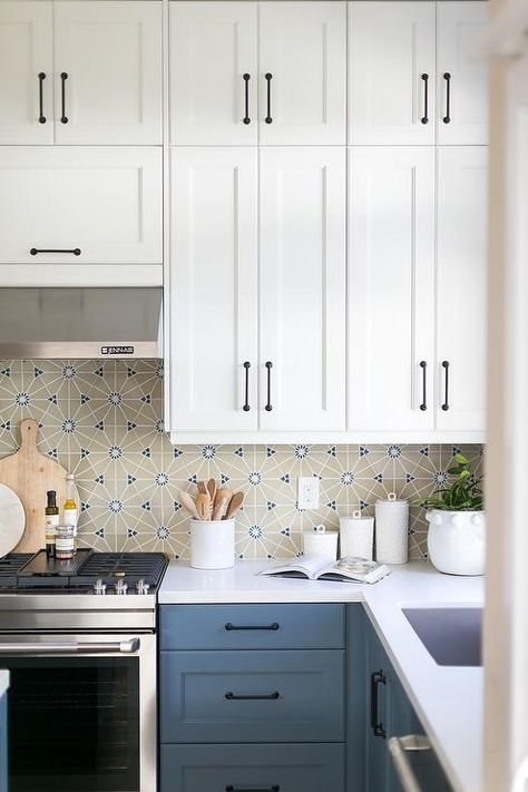 Blue kitchen drawers accented with oil rubbed bronze pulls and a white quartz countertop fixed against beige and blue mosaic backsplash tiles. White Upper Cabinets Blue Lower, Blue Lower Kitchen Cabinets, White Upper Cabinets, Top Kitchen Cabinets, Bronze Pulls, White Shaker Kitchen, Blue Kitchen Cabinets, White Shaker Cabinets, Shaker Kitchen Cabinets