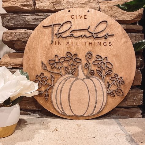 Our 12" Round was so much of a fan favorite... we made it bigger! You can now enjoy the elegant three-dimensional details of our "Give Thanks" sign as an 18" round hanging sign. Display it on your door to welcome guests or inside your home to view anywhere. Engraved Door Signs, Painted Laser Engraving, Wooden Thanksgiving Signs, Laser Engraved Fall Decor, Halloween Laser Engraving Ideas, Thanksgiving Laser Projects, Fall Wood Rounds, Fall Laser Cut Decor, Fall Laser Engraving Ideas